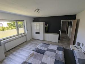a bedroom with a bed and a large window at Einfach Bärig in Giengen an der Brenz