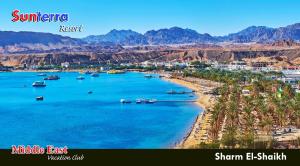 a view of a beach with boats in the water at Sunterra Resort in Sharm El Sheikh