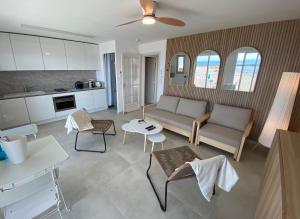 a living room with a couch and a table at Les pieds dans l'eau - Carnon plage in Carnon-Plage