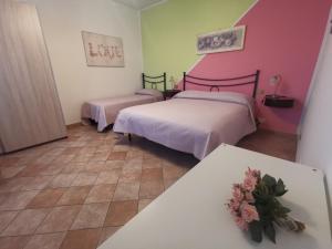 Ένα ή περισσότερα κρεβάτια σε δωμάτιο στο Villa Lucia B&B
