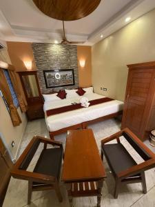 a bedroom with a large bed and two tables in it at Lake View Residency in Puducherry