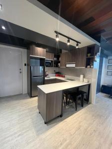 a kitchen with a large island in the middle at Urban Luxe Oasis in Bacolod