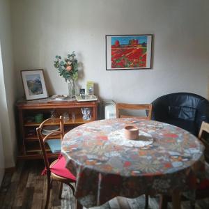 a dining room with a table and chairs with a table and a table at Tour Rose in Frangy +6 photos