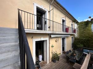 a balcony of a house with a stairway and a building at Le Magnolia in Canet
