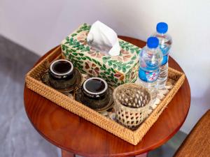 a table with a box and a bottle of water at Adumi Retreat Tam Cốc in Vũ Lâm