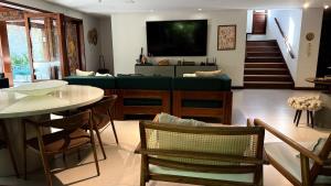 a living room with a couch and a table at Canto das Pedras House in Mata de Sao Joao