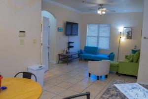 a living room with a couch and a table at Clean Pool Walk to Beach - Pet Ok - Ground Floor in South Padre Island