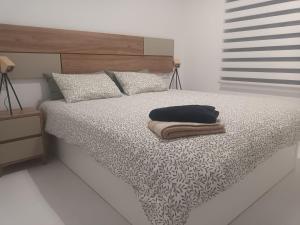 a bedroom with a bed with a black and white comforter at Cosy Casa New penthouse in San Miguel de Salinas +55 photos