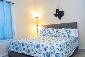 a bedroom with a bed with blue and white sheets at Clean Pool Walk to Beach - Pet Ok - Ground Floor in South Padre Island +60 photos