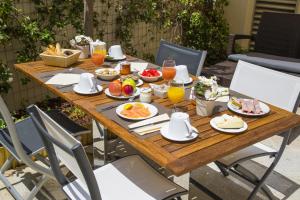 a wooden table with breakfast food on it at Cristal Hôtel & Spa in Cannes