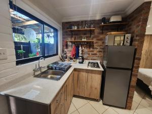 a kitchen with a sink and a refrigerator at The Forage Box - Artist's Studio in White River