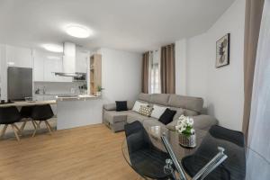 a living room with a couch and a table at Apartamento Refugio del Mar in Candelaria +15 photos