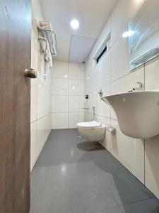 a bathroom with a sink and a toilet at SwagStay Hotel Riviera Grand, Nagpur in Nagpur