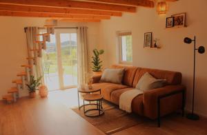 a living room with a couch and a window at Maia in Wiltz