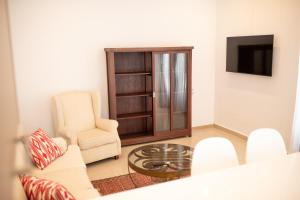 a living room with a couch and a chair and a tv at Casa Hermosamía in Vélez Rubio
