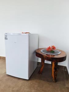 a table with a plate on it next to a refrigerator at Amara Nakupenda Villa JJ in Nungwi
