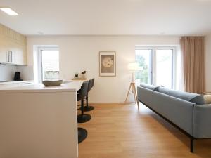 a kitchen and living room with a couch and a table at Seenah2, privater Garten, Stellplatz, Strandnähe in Sassenberg