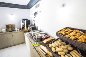 a kitchen with a counter with baskets of bread at Cristal Hôtel & Spa in Cannes