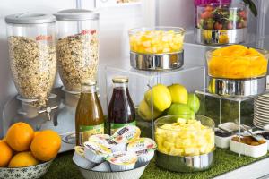a refrigerator filled with fruit and other food items at Cristal Hôtel & Spa in Cannes