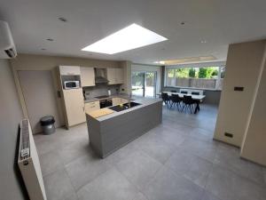 a kitchen with an island in the middle of a room at Villa d'Houthem in Kasteelhoek