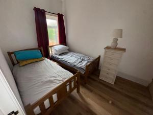 a bedroom with two twin beds and a window at Daniel’s Semi Rural Retreat in Clowne