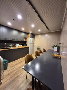 a conference room with a table and chairs and a kitchen at Hostel Navi Osh in Osh