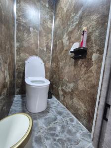 a bathroom with a toilet and a sink at Hostel Navi Osh in Osh