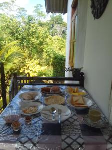 a table with a bunch of food on it at Villa tharu hikkaduwa in Hikkaduwa