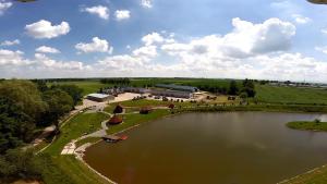 an aerial view of a large lake with a building at Domek letniskowy Łowisko Frączków 