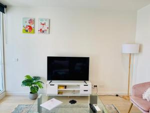 a living room with a tv on a white wall at Comfy Unit in front of Crown with Free Parking in Melbourne