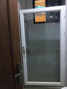 a glass door to a shower in a bathroom at Apple Luxury Apartments in Kigali +22 photos