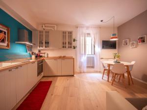 a kitchen with a table and a dining room at La Casa di Nina e la Luna in Perugia +9 photos