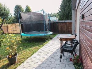 a backyard with a trampoline with a table and a tableablish at Bungalov Vlnka in Vlachy +6 photos