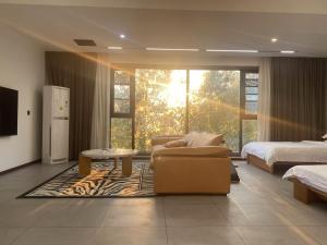a living room with a couch and a bed and a table at 52 Creative Workshop Hotel in Shanshiwang