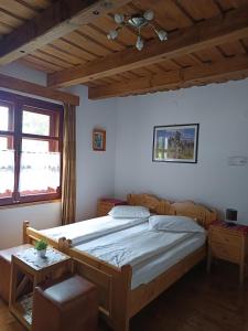a bedroom with a large bed and a wooden ceiling at Pensiunea Nostalgia in Borsec