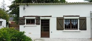 ein weißes Haus mit einer Tür und Fenstern in der Unterkunft Francois Faber in Aulnay-sur-Iton