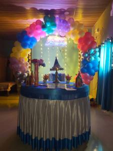 a table with a bunch of balloons on it at Lakshika beach resort in Gokarna