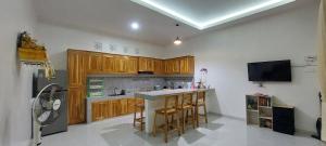 a kitchen with wooden cabinets and a counter top at Villa LOVE INNA, Private, modern with AirCon and Pool in Lovina