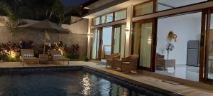 a house with a swimming pool next to a house at Villa LOVE INNA, Private, modern with AirCon and Pool in Lovina