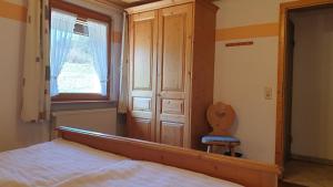 a bedroom with a mirror and a bed and a chair at Appartement In Wittenschwand in Wittenschwand +19 photos
