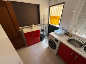 a small kitchen with a sink and a washing machine at Casa Rural Familiar , Castilleja del Campo , Sevilla in Seville +22 photos