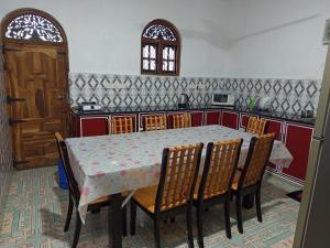 a table and chairs in a kitchen with a table and a counter at Meera Bayside Villas in Oddaimavadi