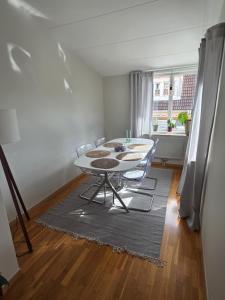 a dining room with a table and chairs in a room at The terraced house in Stockholm