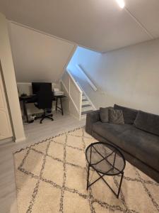 a living room with a couch and a table at The terraced house in Stockholm