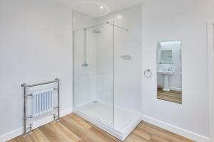 a glass shower in a bathroom with a sink at 96 Roseberry Cottage in the market town of Guisborough in Guisborough +14 photos