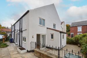 a white house with a fence in front of it at 96 Roseberry Cottage in the market town of Guisborough in Guisborough