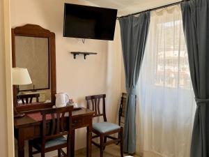 a room with a desk with a mirror and a window at Casa Famiani Bed & Breakfast in Letojanni