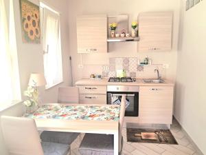 a small kitchen with a table and a sink at La Rosa Verde in Castrovillari