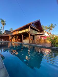 a resort with a pool in front of it at Four Elements Eco Dive Resort in Gili Islands