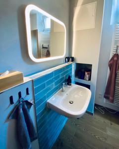 a bathroom with a sink and a mirror at Joe's Home Naumburg -modern,vintage Apartment in Naumburg +27 photos